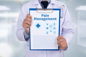 Pain Management Portrait of a doctor writing a prescription